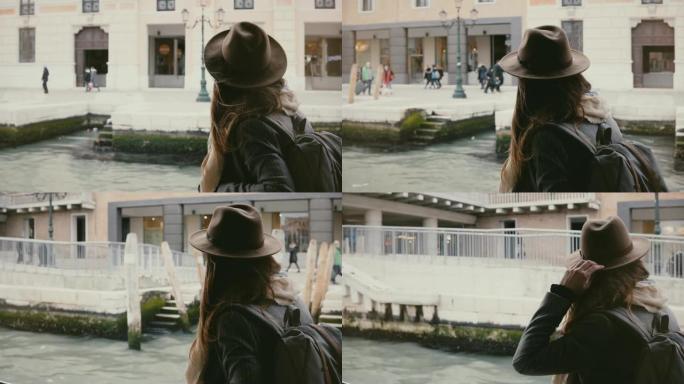 快乐的年轻美丽的旅游女人享受着意大利威尼斯古城河堤令人惊叹的乘船旅行。