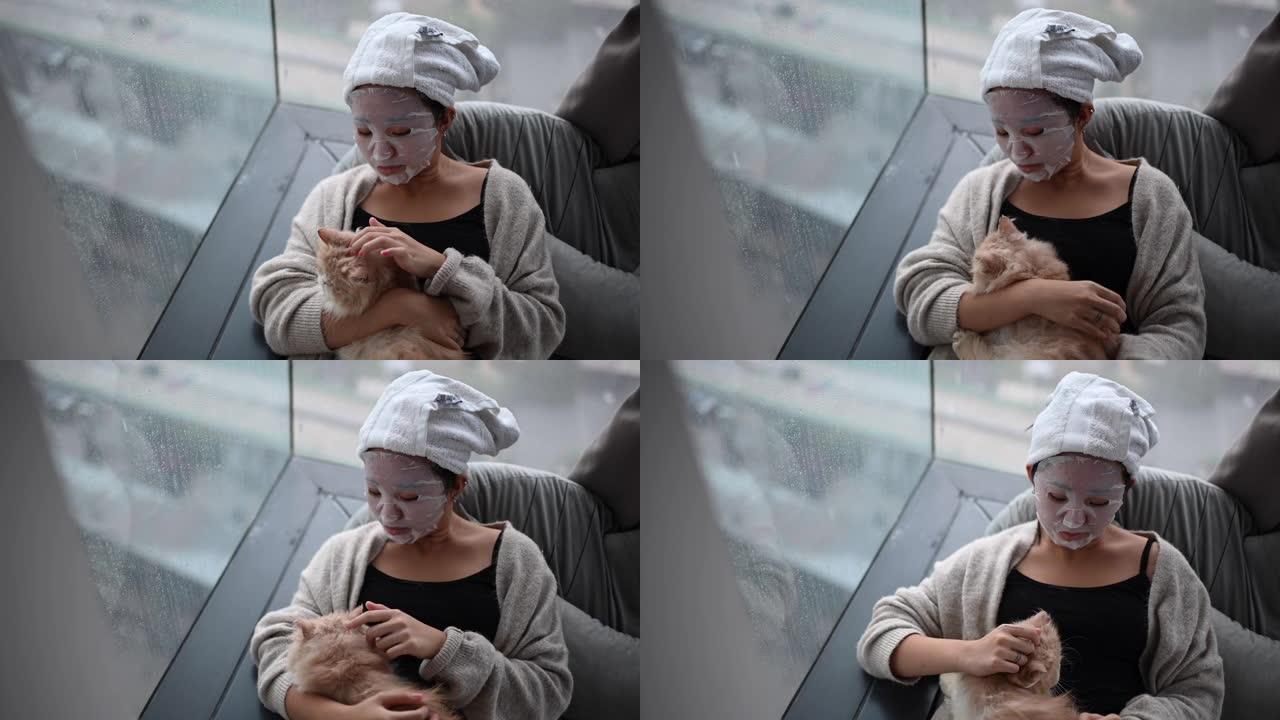 一名亚洲华裔少女在卧室里用猫做面部水疗面膜