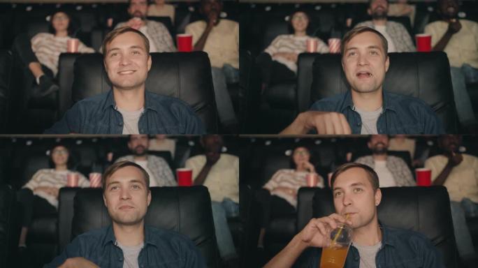 年轻人在电影院看电影时吃爆米花和喝橙汁