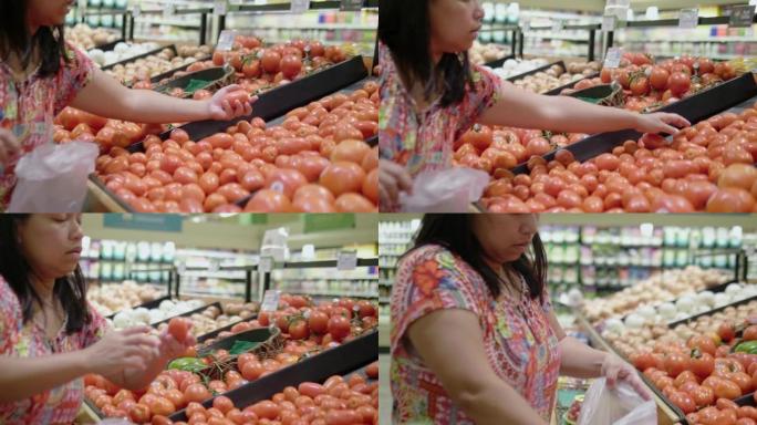 亚洲女人的手在超市选择橘子