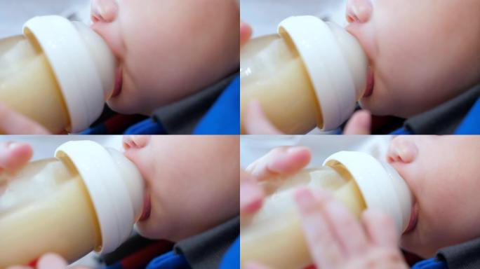 婴儿喝一瓶牛奶婴儿喝奶特写奶瓶