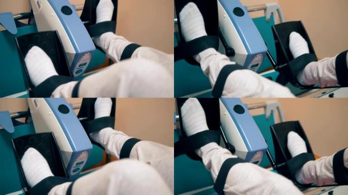 在诊所进行理疗时，患者会在医疗机器上旋转踏板。4K。