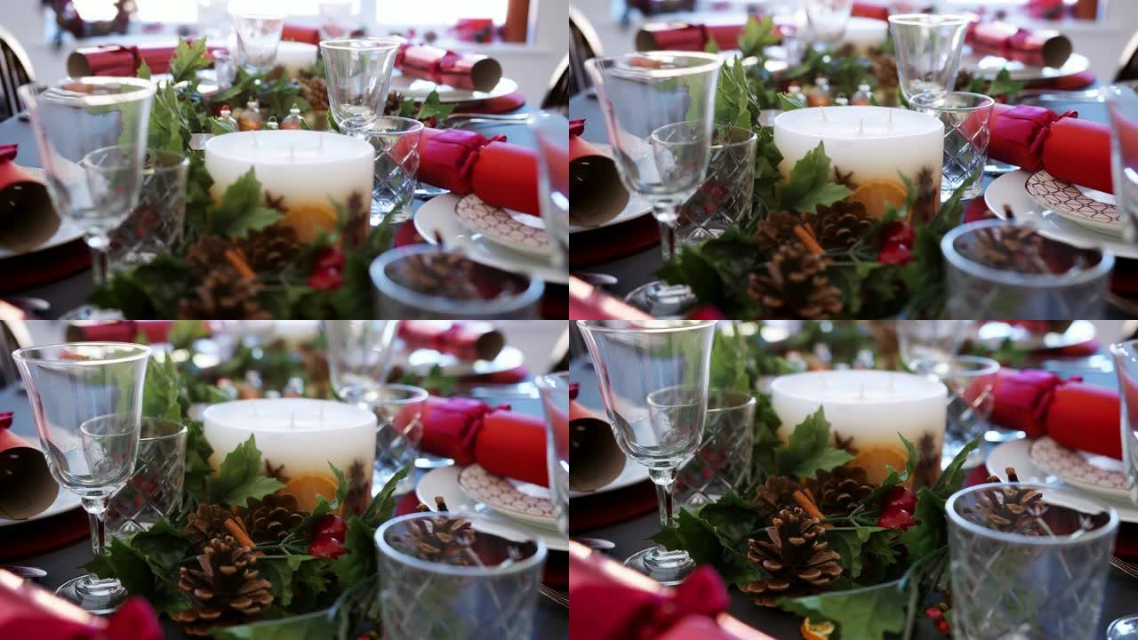 在餐桌上倾斜白色蜡烛的镜头，为圣诞节晚餐做准备，细节，选择性聚焦