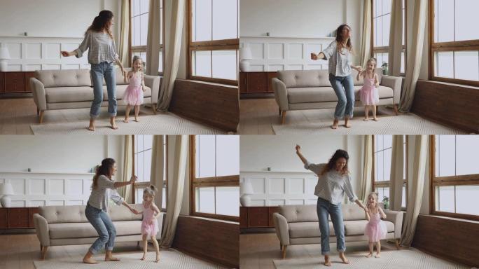 无忧无虑快乐的妈妈和小女儿在家跳舞