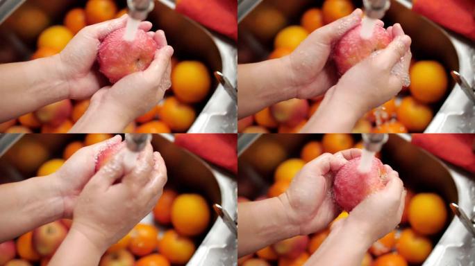 女人在厨房洗手苹果和水果