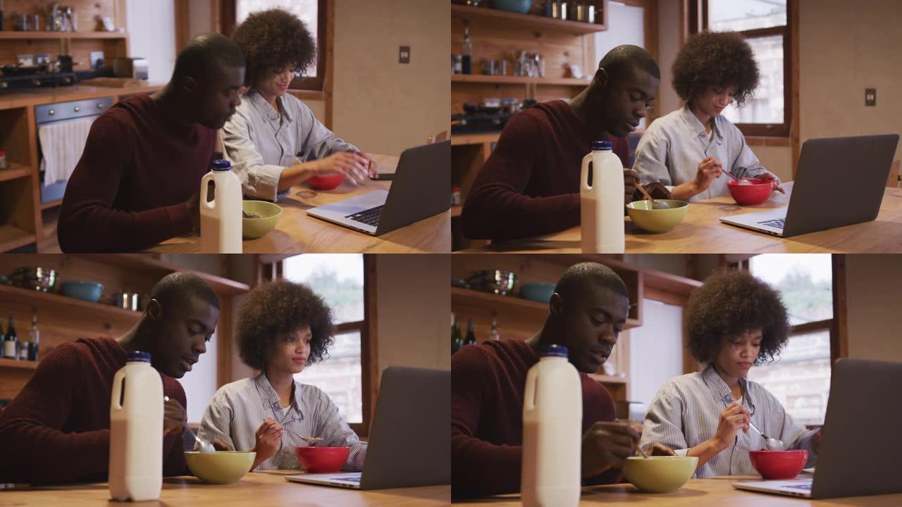夫妇一边吃早餐一边看电脑