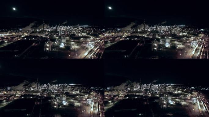 WS鸟瞰图炼油厂和夜间照明的城市景观