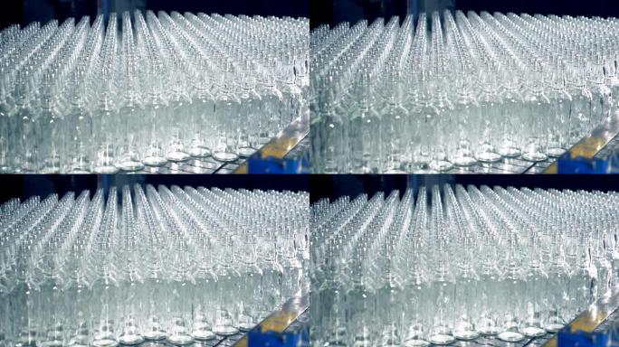 大传送带上有很多透明的瓶子，特写。