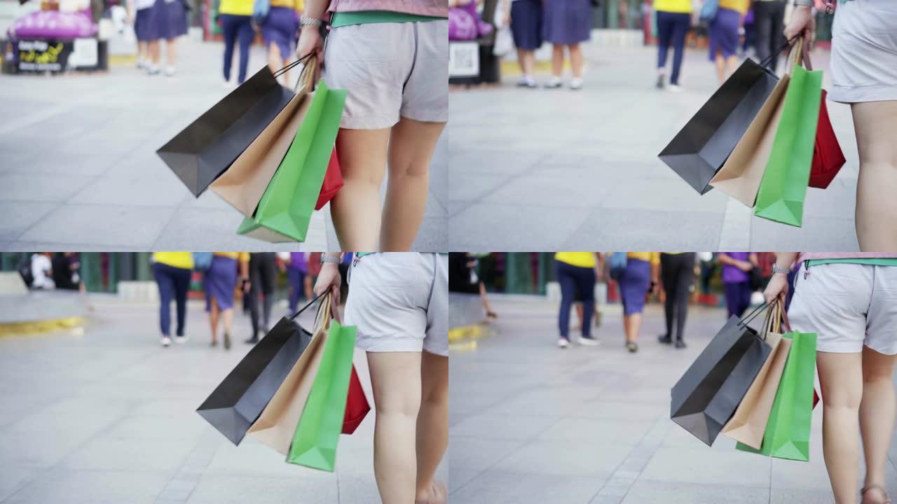 女人带着购物袋走路，慢动作