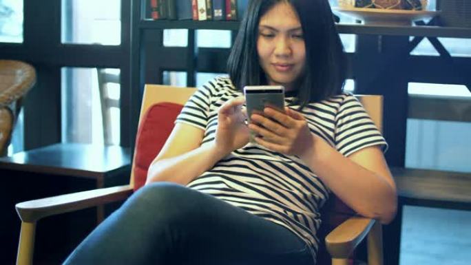 慢动作年轻女子在咖啡馆使用手机