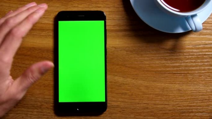 桌上绿屏智能手机点击屏幕手机特写特效