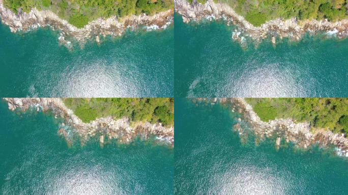 俯视图移开海洋蓝浪冲撞海岸线悬崖。空中4k镜头