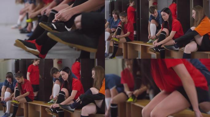 女足球运动员系鞋带并在更衣室准备比赛