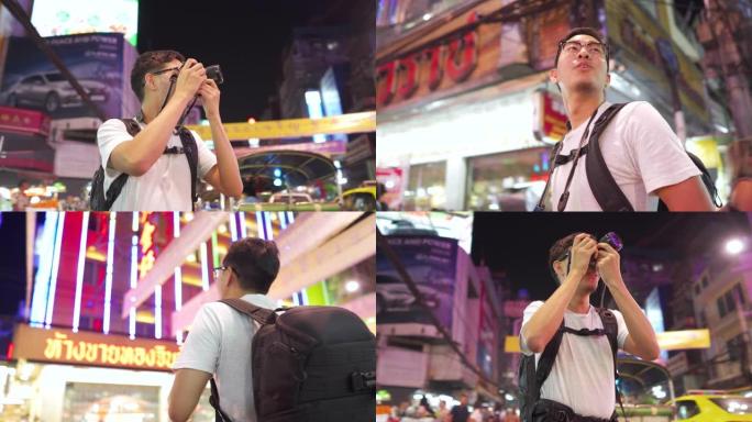 男摄影师在泰国曼谷Yaowarat街头小吃夜市拍摄照片
