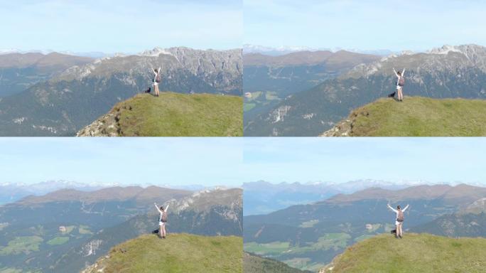 空中: 年轻女子在白云岩徒步旅行庆祝到达山顶。