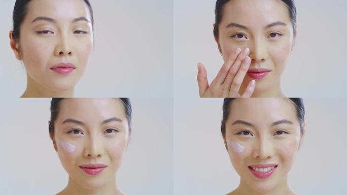 微笑美丽的亚洲女人的慢动作，皮肤完美，刚刚从杂质中清洗干净，用手指轻轻涂抹在脸上，日霜或晚霜
