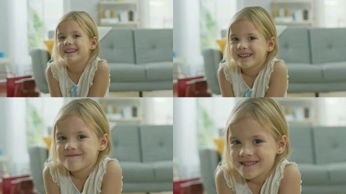 甜美可爱的快乐年轻金发女孩在镜头前微笑的肖像。背景模糊的阳光房间。