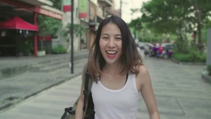 亚洲背包客女人在中国北京旅行感到快乐，开朗美丽的年轻少年博客女性在唐人街散步。生活方式背包旅游度假概