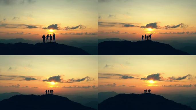 四人在美丽的夕阳下在山上跳舞
