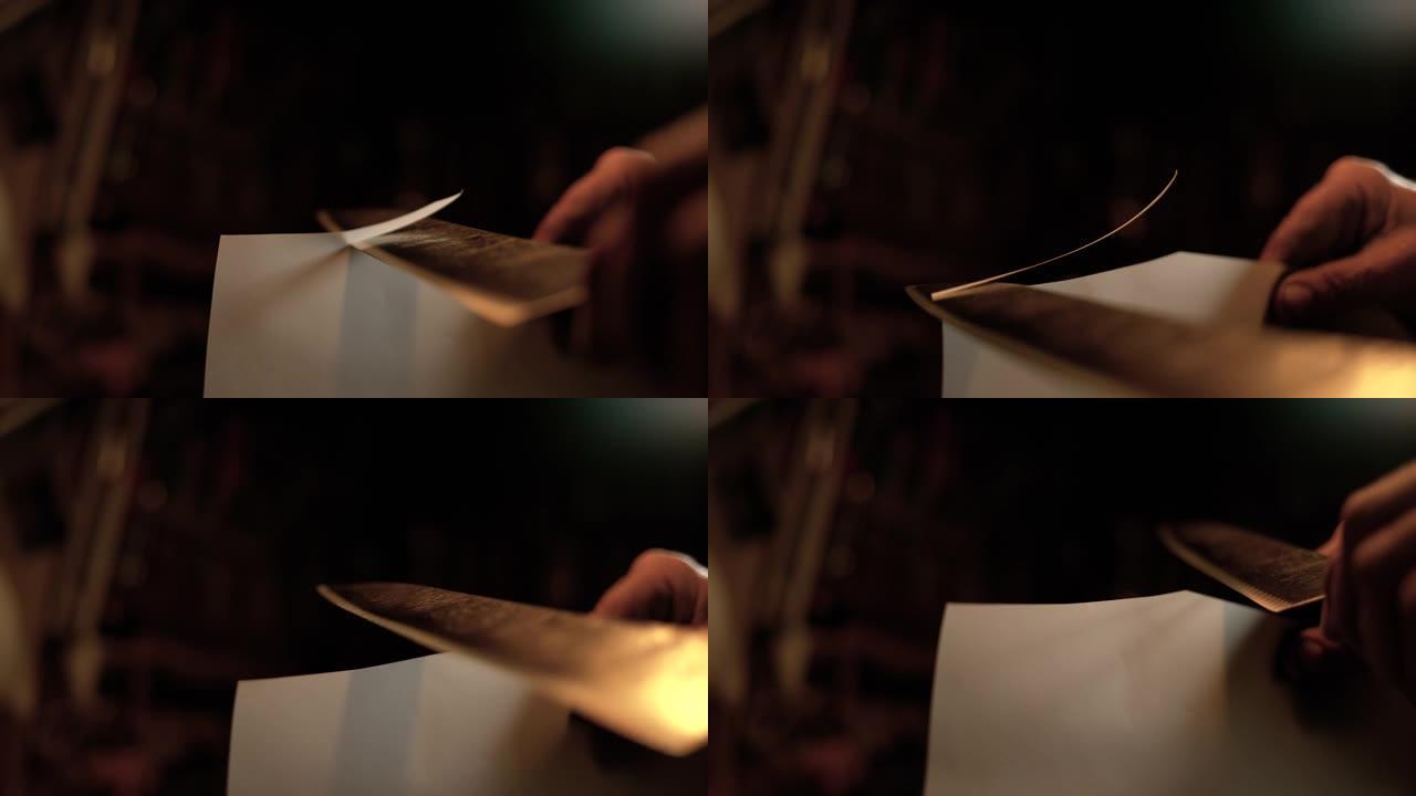 宏观: 锋利的古老刀片毫不费力地切开一张纸。