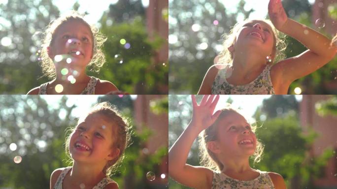 两个可爱的小女孩在房子外面玩肥皂泡的真实照片