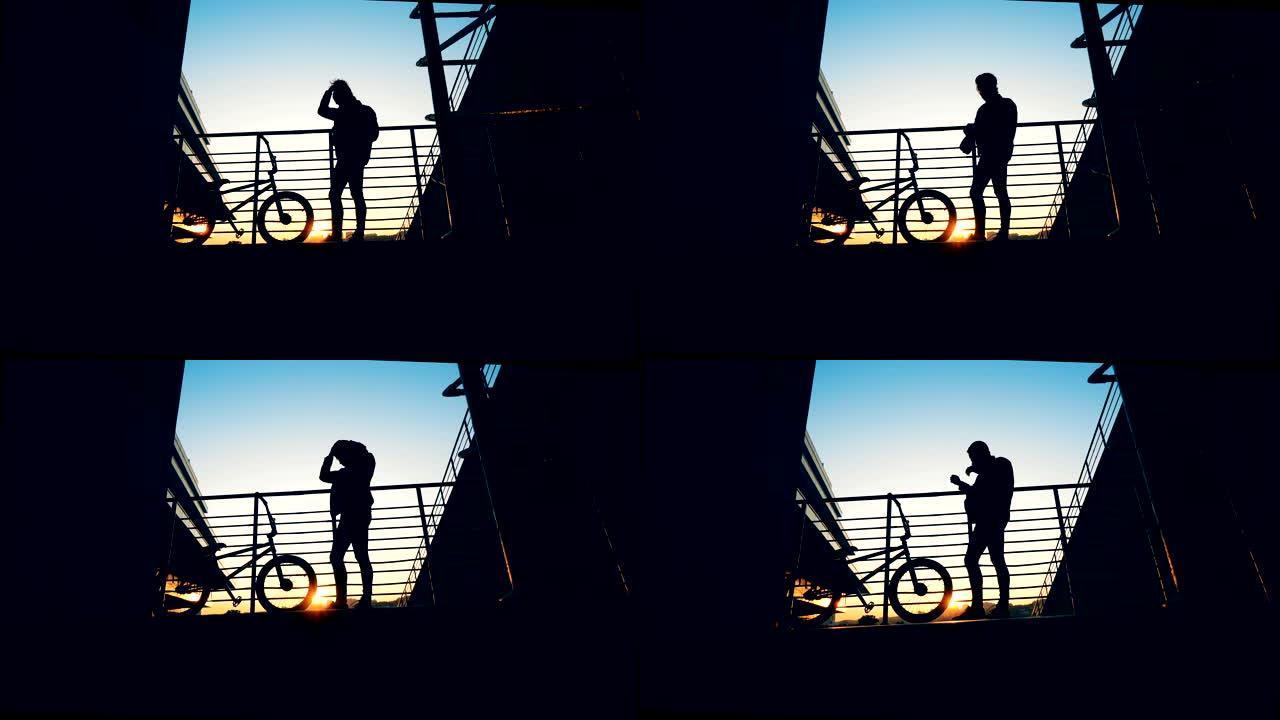 日落时的平台上，一个年轻人做头发，旁边站着一辆自行车