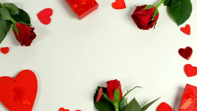 圆形4k白色表面的红玫瑰、礼品盒和五彩纸屑的心形