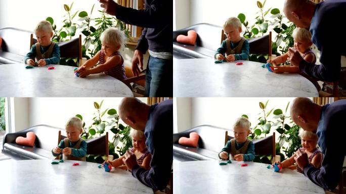 父亲和孩子们在舒适的家庭中与黏土一起玩耍4k