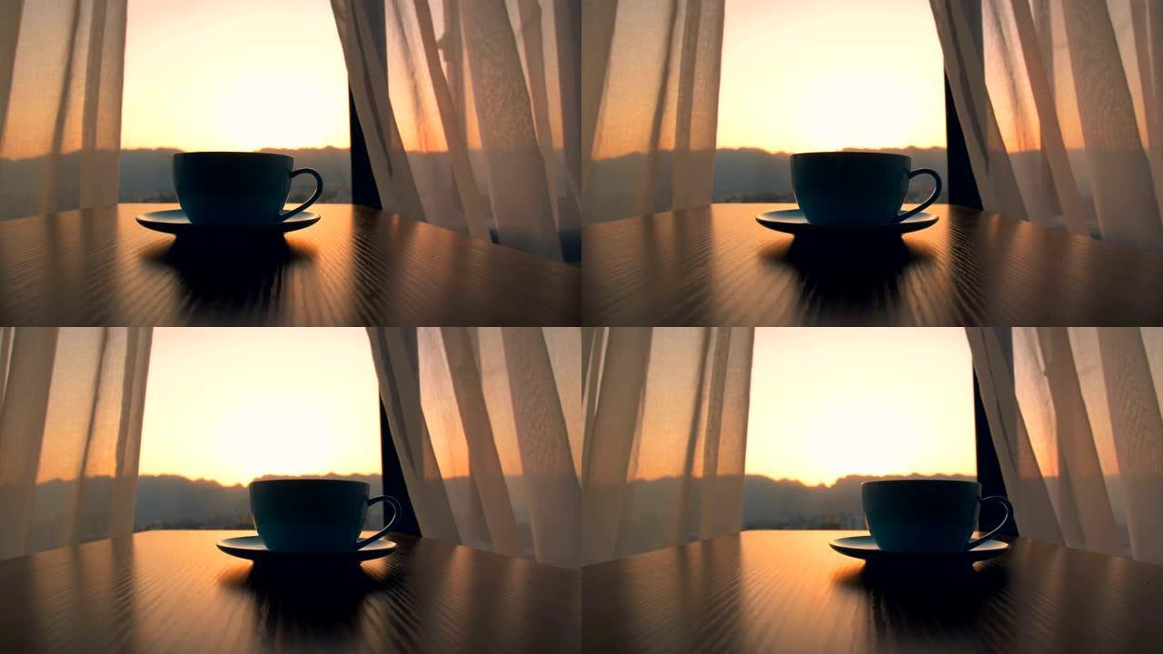 在日出背景下桌上的咖啡杯