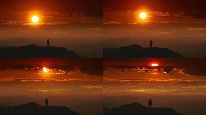 男性站在日出背景的山顶上。时间流逝