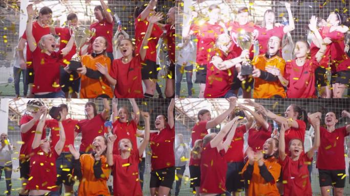 女子足球运动员的获胜者团队与五彩纸屑合影