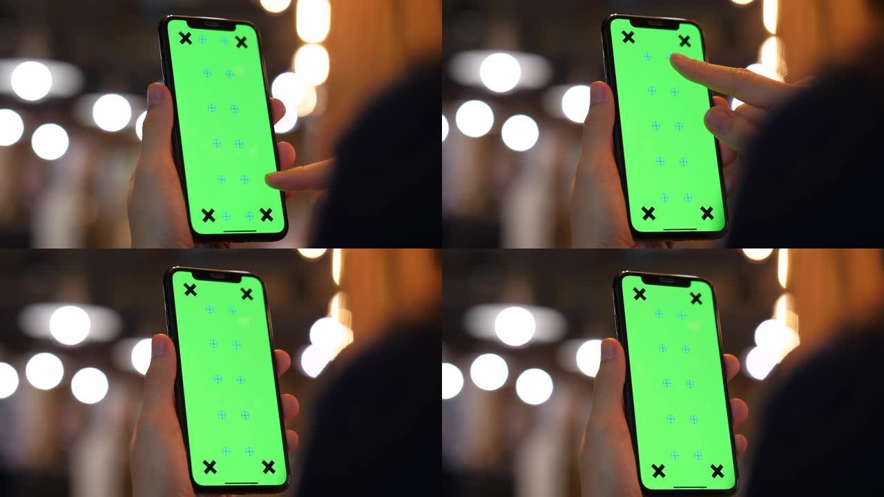 年轻女子使用带有绿屏的智能手机