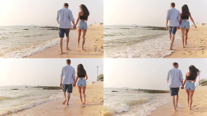 4k分辨率混合种族年轻夫妇在沙滩上行走，手持慢动作场景，手持B-roll