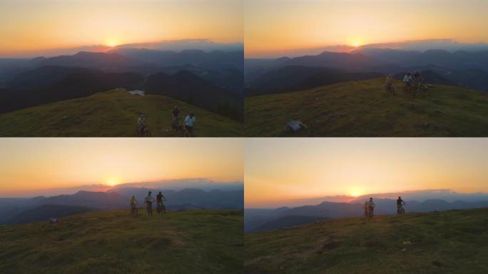 空中: 在日落时分骑着山地车冒险的朋友