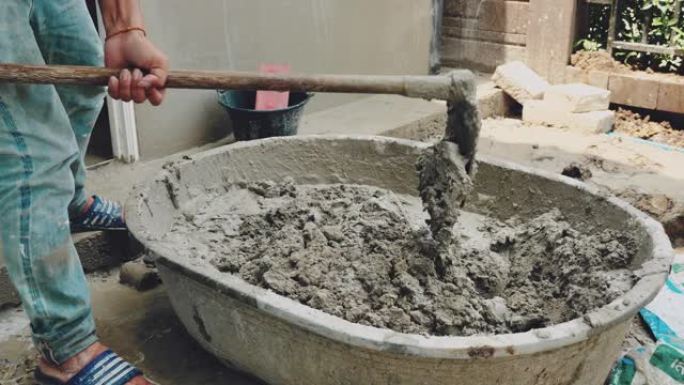 将水泥与水混合用于建筑施工的工人