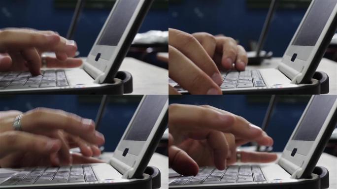 男人用他的笔记本电脑把手放在键盘上。