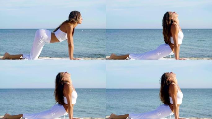 美丽的女人在海上做瑜伽，和谐与自由，海沙背景