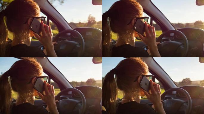 女人开车时在手持设备上打电话