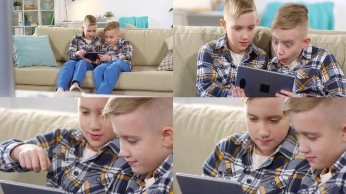 高加索双胞胎兄弟在家里的平板电脑上观看视频