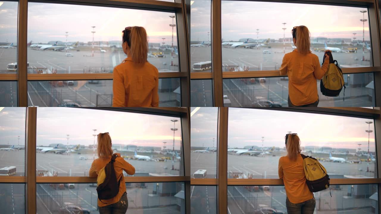 从机场窗户看女人的背面视图