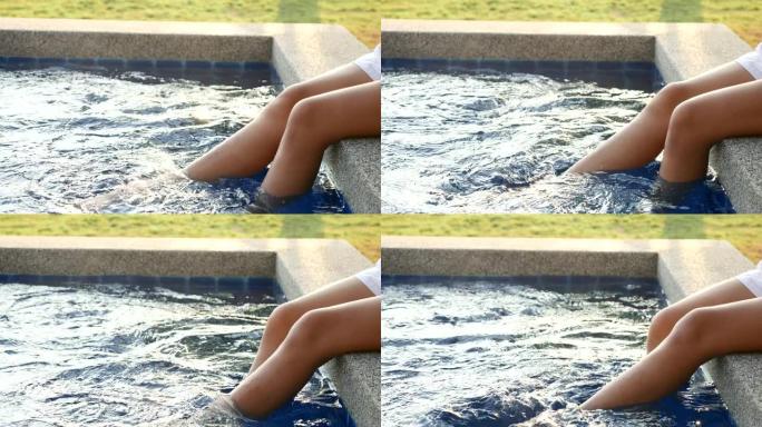 腿部女子放松游泳池的特写