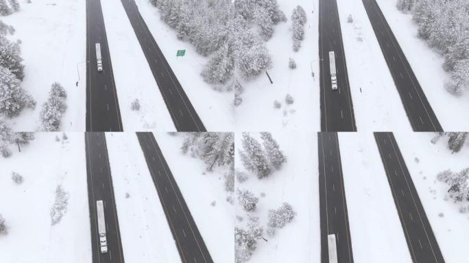 空中: 在暴风雪中沿着湿滑的高速公路飞驰的卡车上方。