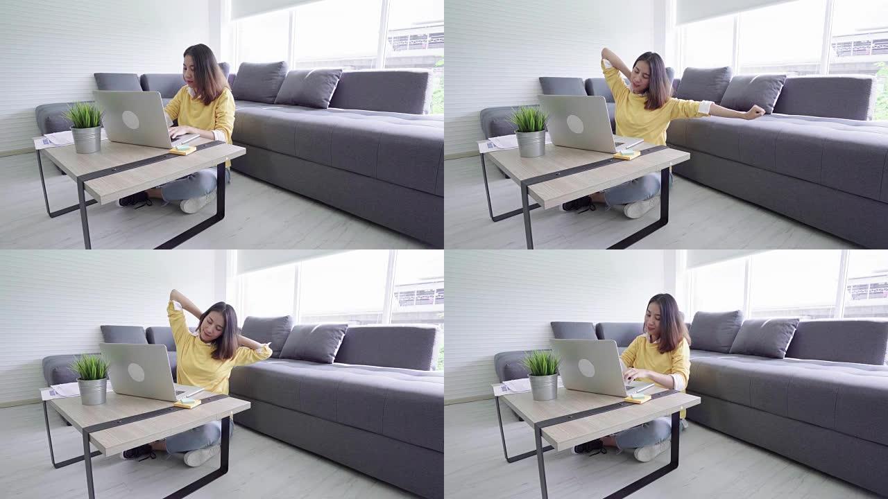 4k分辨率美丽的年轻亚洲女孩坐在笔记本电脑上工作，在家放松
