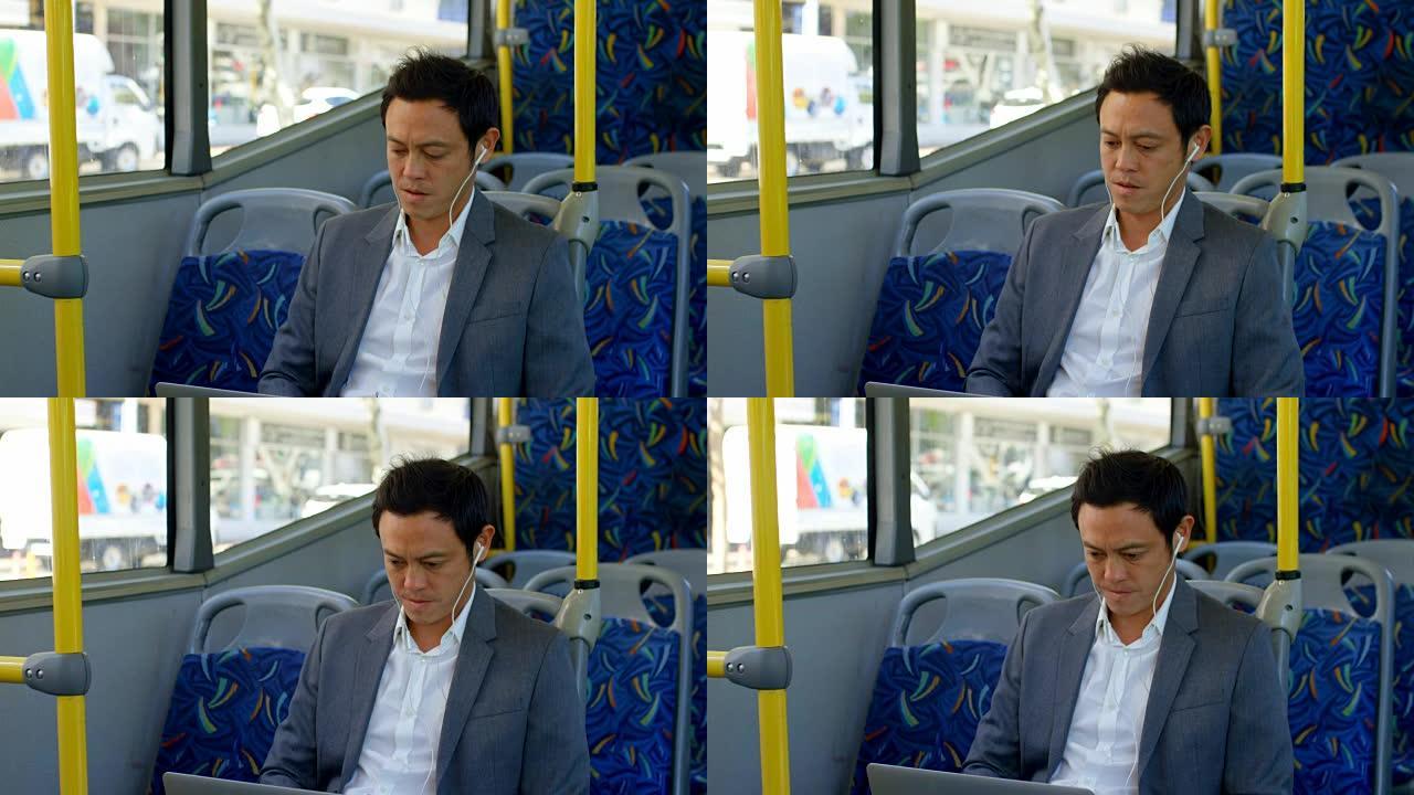 商务通勤者乘坐4k公交车时在笔记本电脑上听音乐