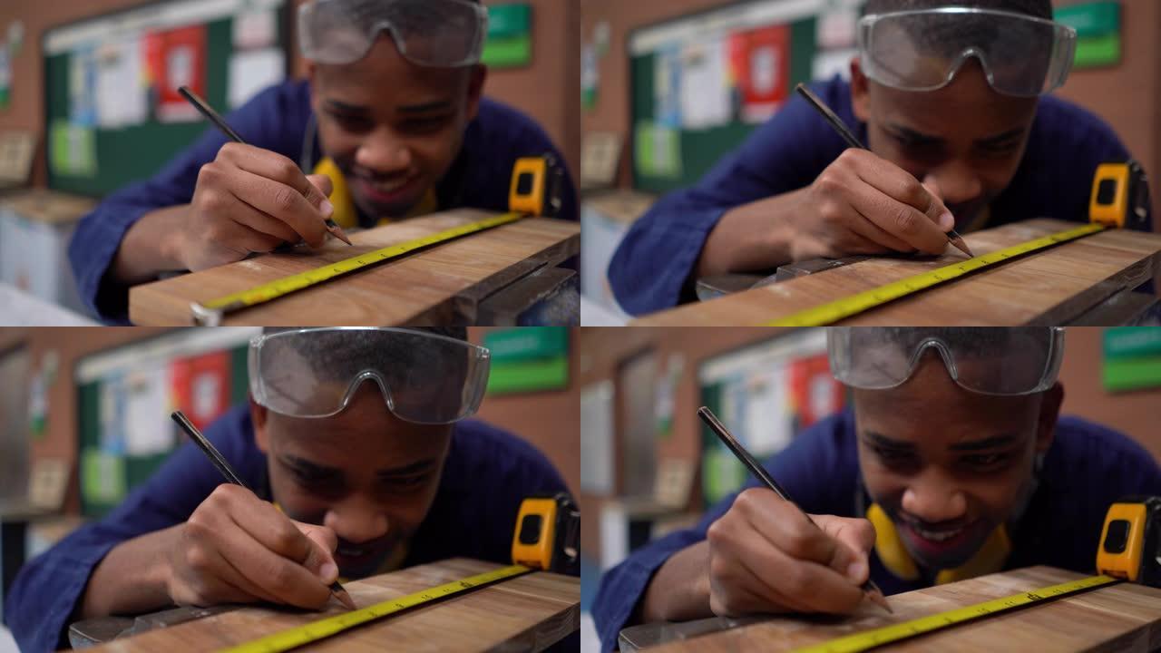 在工作坊课上，开朗的黑人学生用铅笔和仪表测量木片的特写
