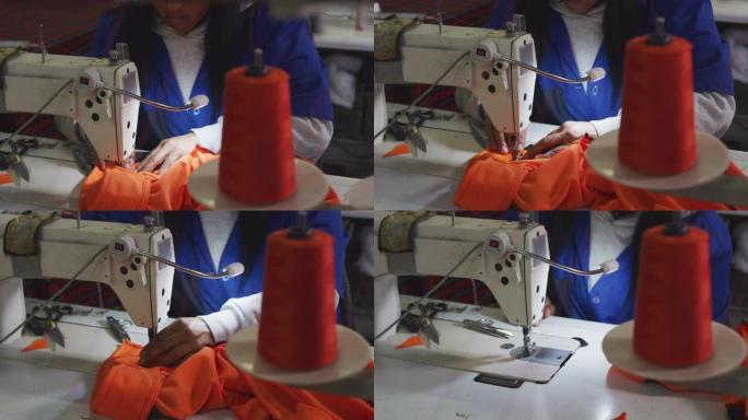 混血妇女在工厂使用缝纫机