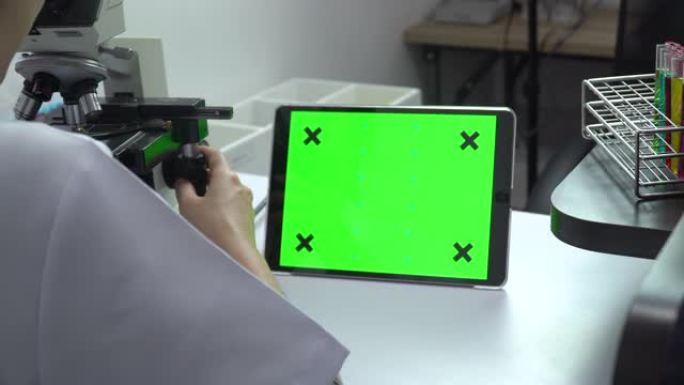 女研究科学家使用绿屏数字平板电脑