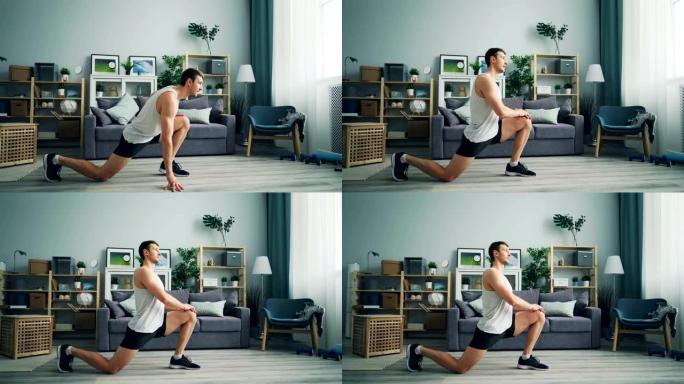 穿着运动服的好看的年轻人在家锻炼腿