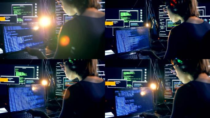 黑客在笔记本电脑上打字，破解系统，后视图。