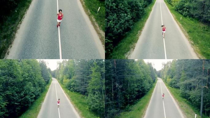 一个漂亮的年轻女子在森林里高速公路上奔跑的俯视图。空中。